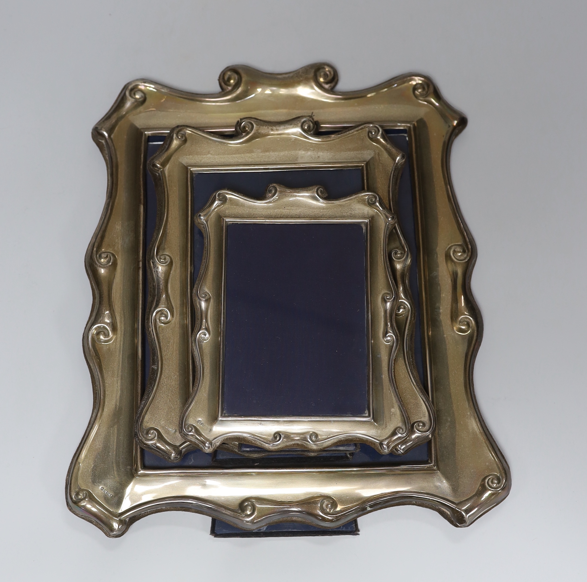 A modern graduated set of three silver photograph frames, Carr's of Sheffield Ltd, Sheffield, 1987/8, largest 35.7cm.